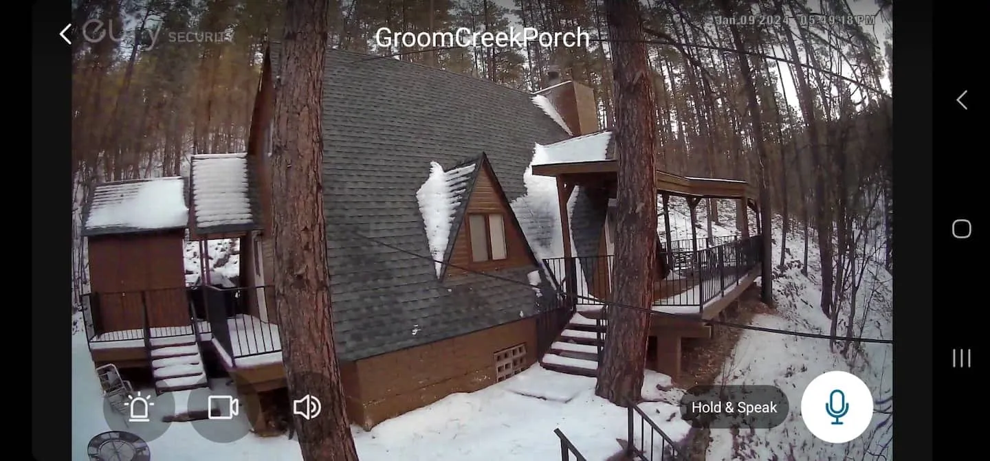 The cabin tucked in the pines after a fresh snow