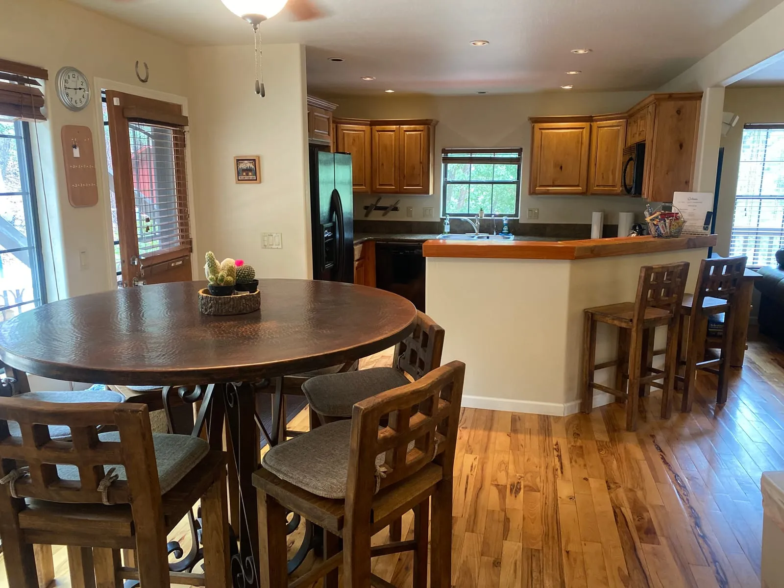Full kitchen with a breakfast bar opening to the dining table