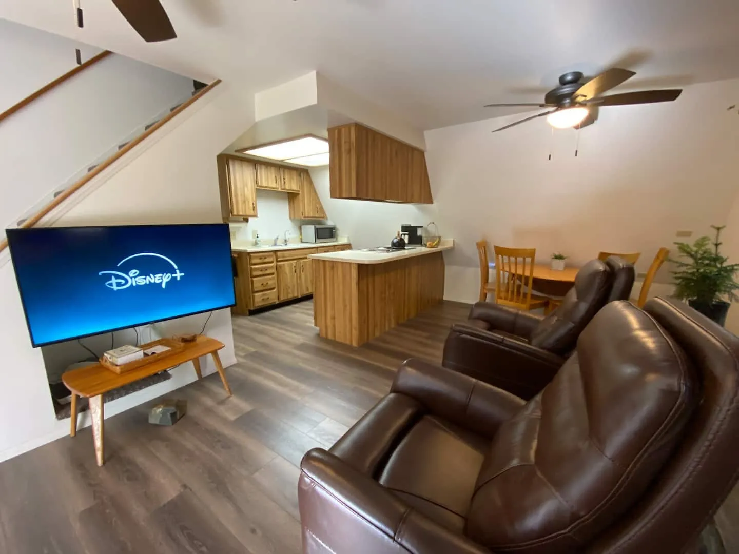 Living area with a smart TV and the kitchen just beyond