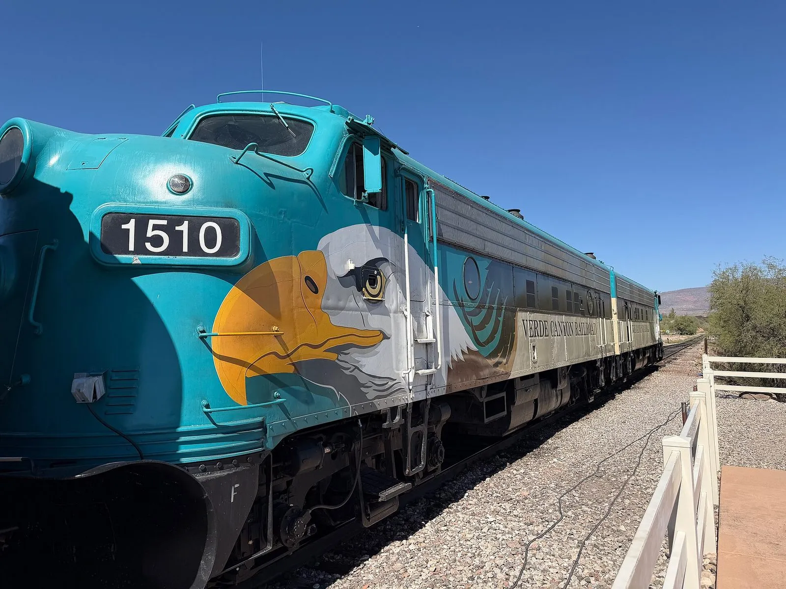 The Verde Canyon Railroad locomotive in teal livery with an eagle painted on the nose